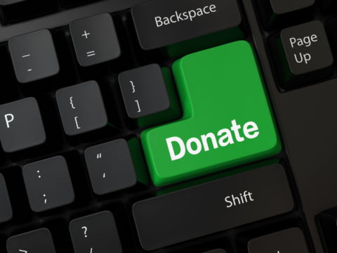 A keyboard showing a green 'donate' button