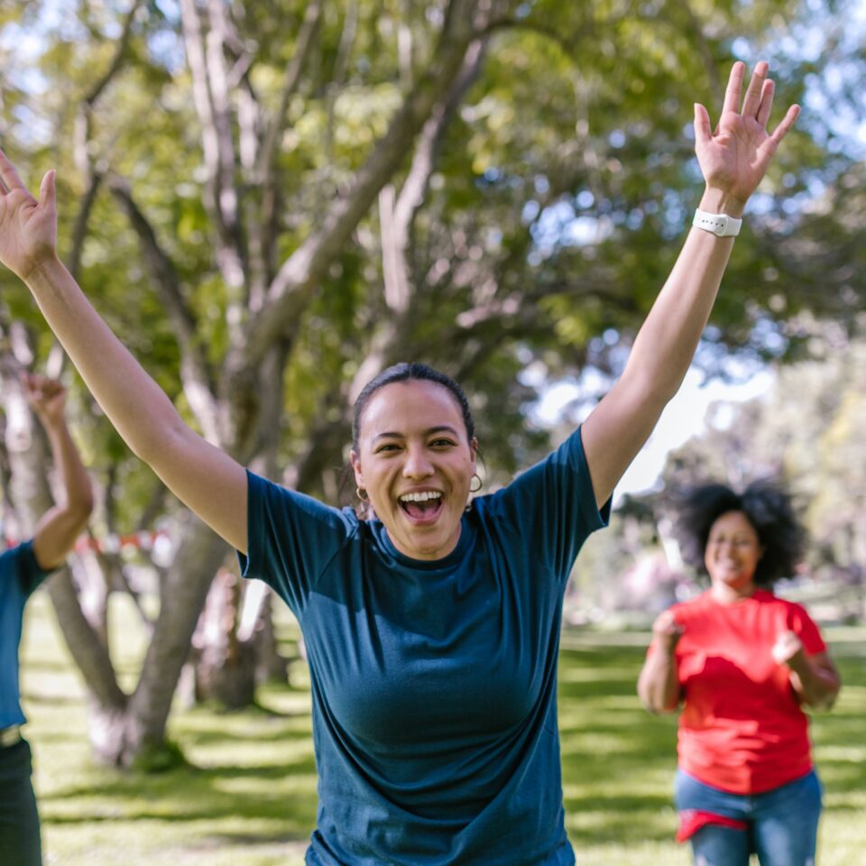 The image shows people celebrating in a a park.