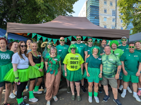 Team Survive pose for a photo at the 2025 York Rotary Dragon Boat Race. Everyone is dressed in green, as a nod to Survive's branding colours.